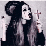 a girl with horns is holding a cross in her hand .