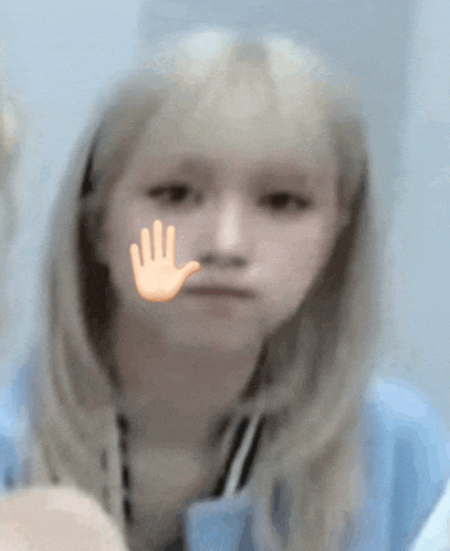 a girl with a hand on her face