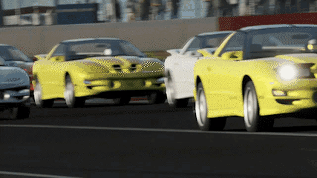 a row of yellow and white cars are driving down a road