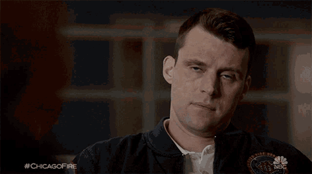 a man is covering his face with his hand and the hashtag #chicagofire