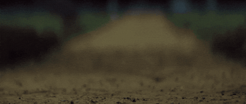 a person laying on the ground with a broken piece of glass on the ground