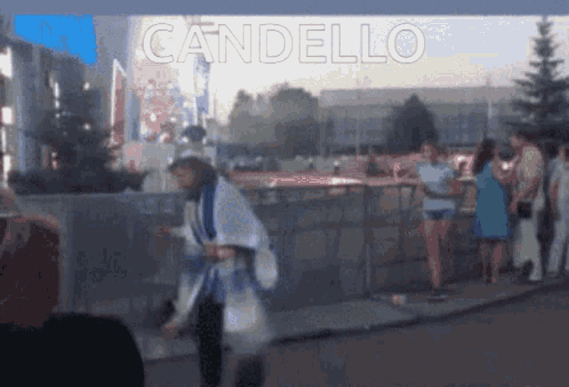 a blurry picture of a person with the word candello on the bottom right