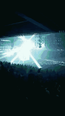 a dark room with a light coming from the ceiling
