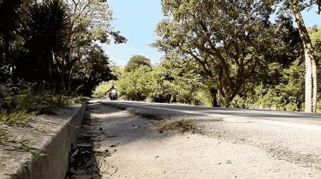 a person riding a motorcycle down a road