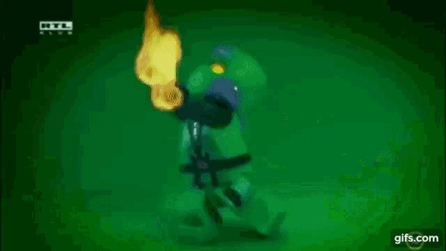 a green tornado is spinning in the dark on a dark background .