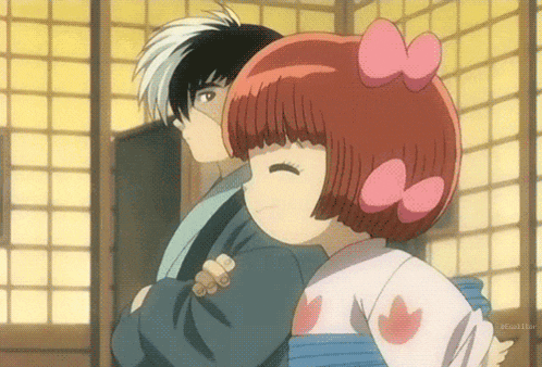 a girl with red hair and a pink bow on her head is hugging a boy with black hair
