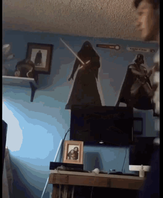 a room with a picture of darth vader and a picture of a monkey