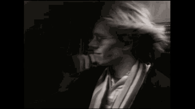 a black and white photo of a woman wearing glasses