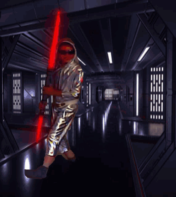 a person holding a red lightsaber in a dark room