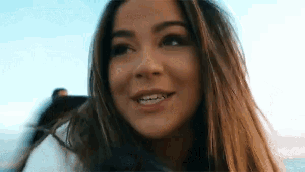 a close up of a woman 's face with her mouth open
