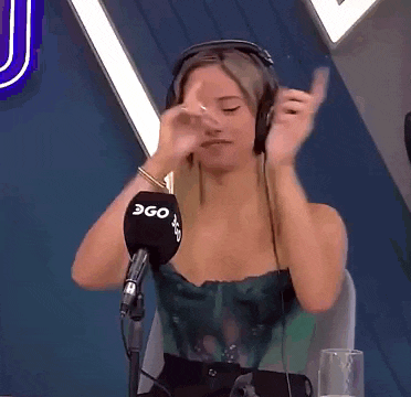 a woman wearing headphones is sitting in front of a microphone that says 360