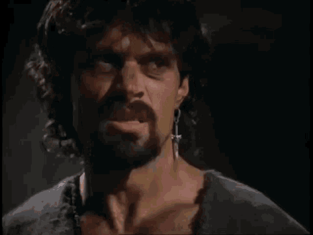 a man with a beard says " do n't be fools " in a dark room