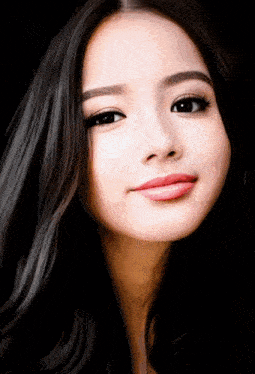 a close up of a woman 's face with dark hair