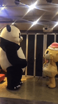 a panda bear and a teddy bear are dancing together