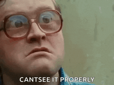a man wearing glasses and a blue shirt is making a funny face and saying `` cantsee it properly '' .