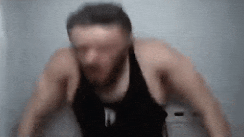 a blurry picture of a man doing push ups in a gym .