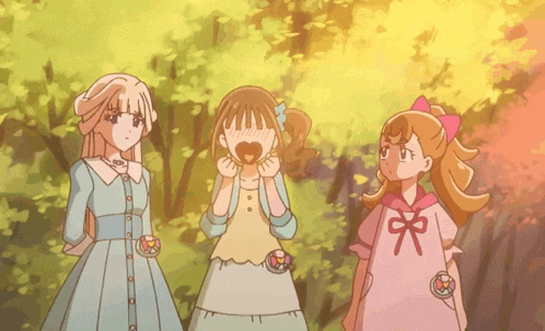 three girls are standing next to each other in a forest