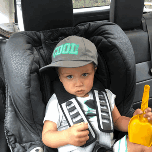 a baby wearing a hat that says cool