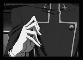 a black and white image of a person talking on a cell phone .