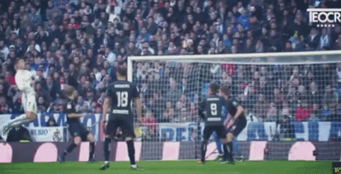 a soccer player with the number 19 on his back is jumping in the air
