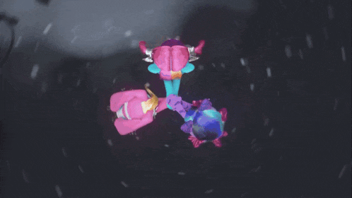 a group of stuffed animals are dancing on the ground
