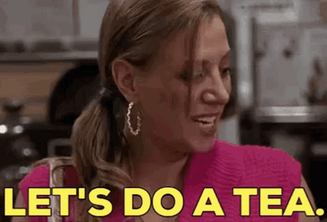 a woman in a pink shirt is smiling and saying `` let 's do a tea . ''