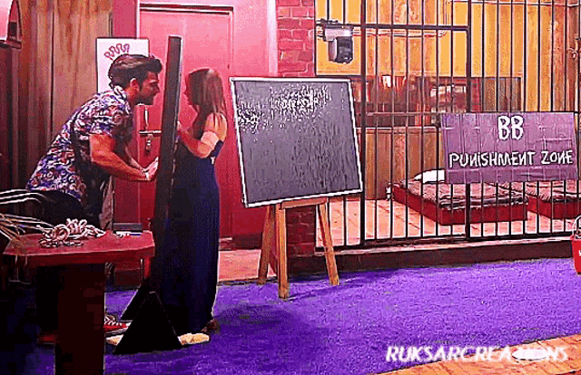 a man and a woman are standing in front of a sign that says bb punishment zone