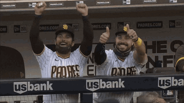 two padres baseball players are giving a thumbs up