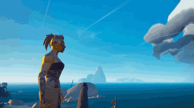 a statue of a woman stands on a rock overlooking a body of water
