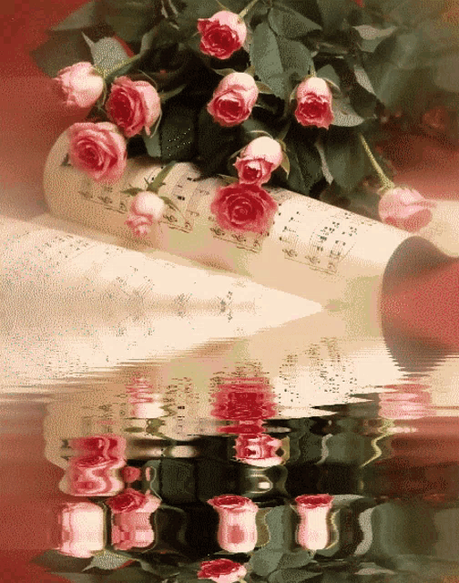 a bunch of pink roses laying on top of a sheet of music