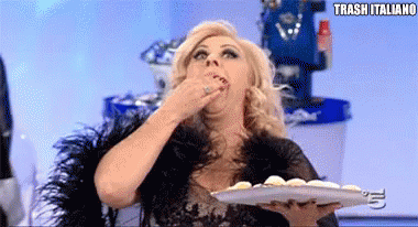 a woman is holding a plate of food and eating it with the words trash italiano below her