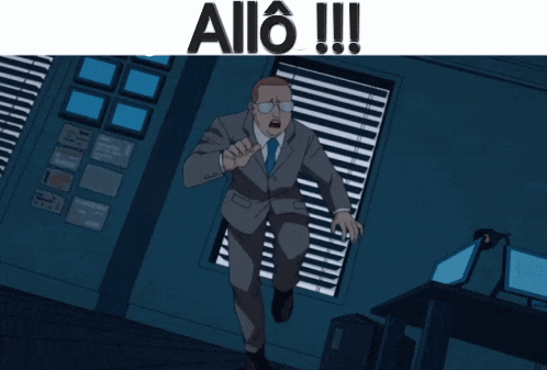 a man in a suit and glasses stands in front of a window with blinds that says allo