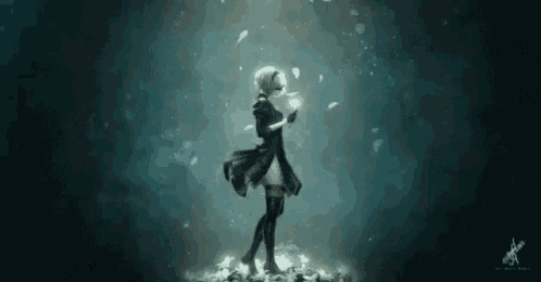 a woman in a black dress is holding a light in her hand .
