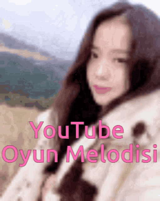 a blurred image of a woman with the words youtube oyun melodisi written below her