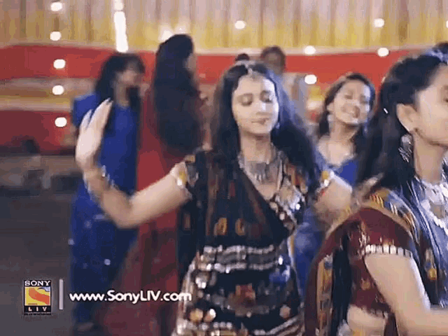 a group of women are dancing in a room with a sony logo in the corner