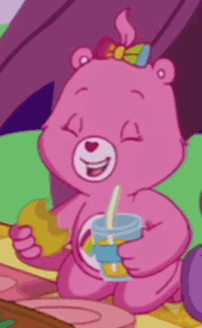 a pink care bear is drinking a drink through a straw while eating a sandwich .