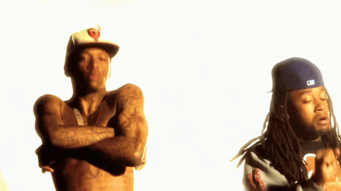a shirtless man in a green hat is standing next to another shirtless man in a blue hat