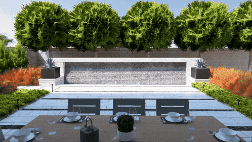a dining table with plates and cups on it in front of a waterfall