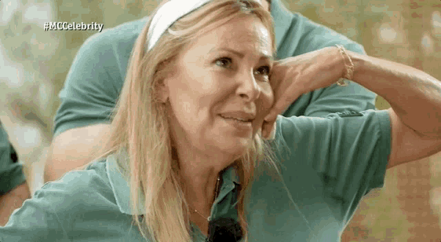 a woman wearing a headband and a green shirt with the hashtag #mccelebrity