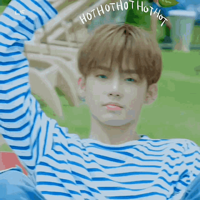 a young man wearing a blue and white striped shirt says hot hot hot hot hot hot
