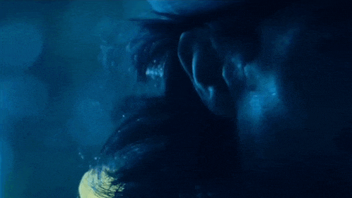 a man in a top hat is standing in a forest at night