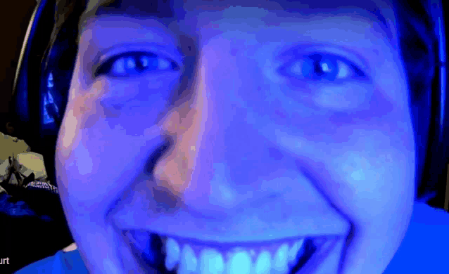 a close up of a person 's face with a blue background and the word burt on the bottom right