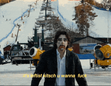a man stands in front of a ski lift with the words it 's leftist kitsch u wanna fuck above him