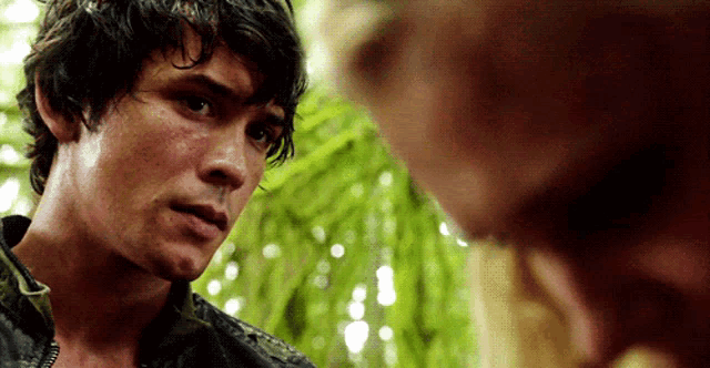 a man with wet hair looks at another man