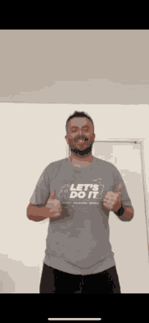 a man wearing a shirt that says let 's do it
