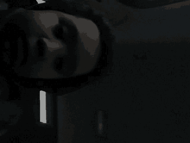 a close up of a person 's face with a light shining on it