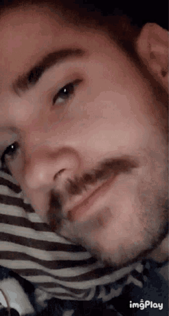 a close up of a man 's face with the words imgplay visible