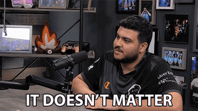 a man sitting in front of a microphone with the words " it does n't matter "