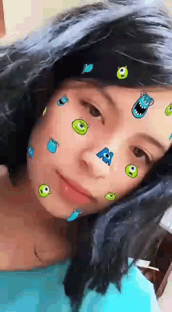 a girl wearing a headband with monsters on her face