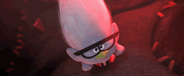 a cartoon troll with glasses and a green tongue sticking out